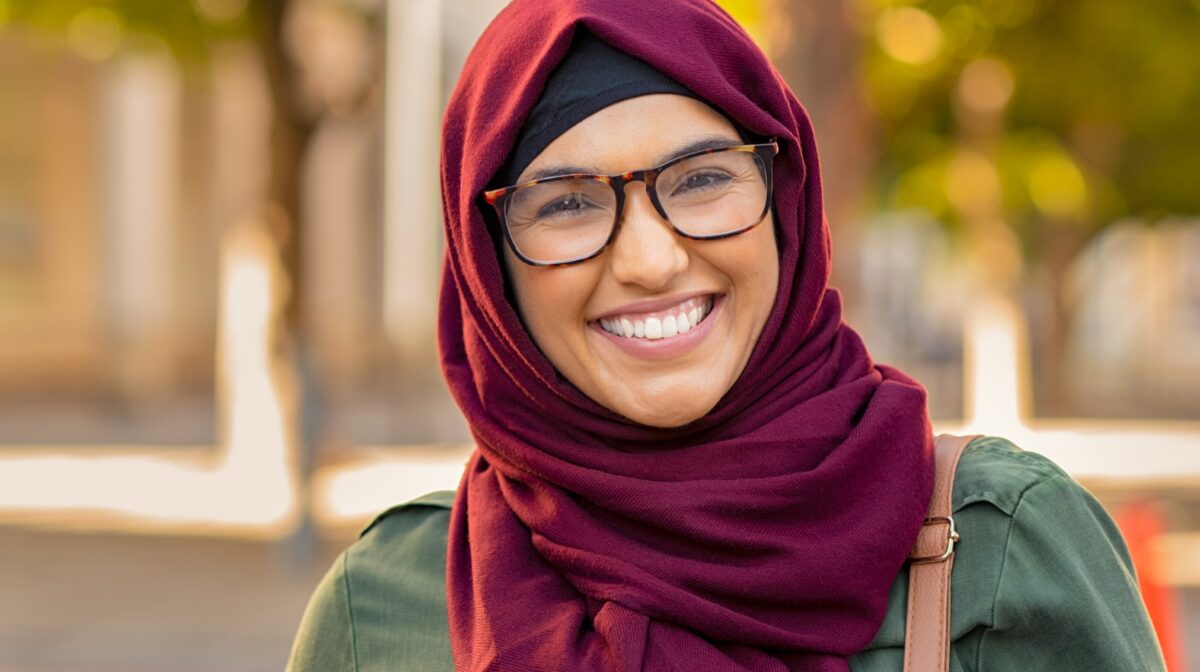 A close up of a smiling woman of color.