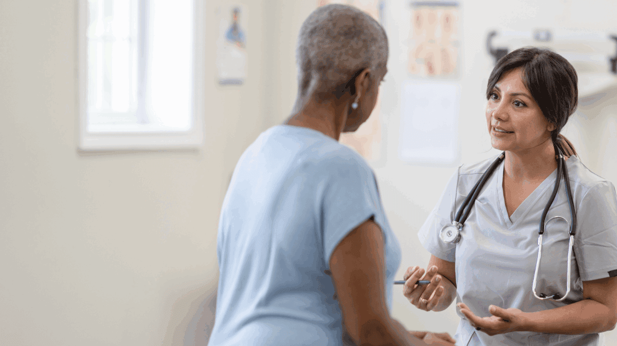 Woman and her doctor discussing the emotional stages of cancer patients.