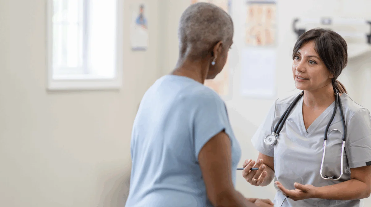 Woman and her doctor discussing the emotional stages of cancer patients.