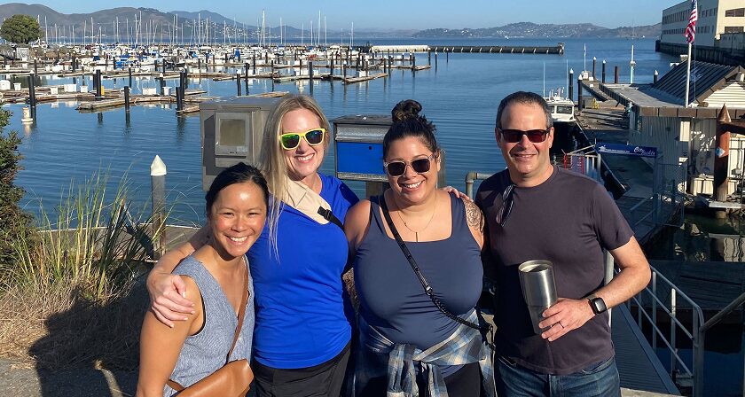 4 Grayce team members posing for a photo on a sunny day.