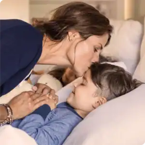 Mother kissing her son on the forehead.